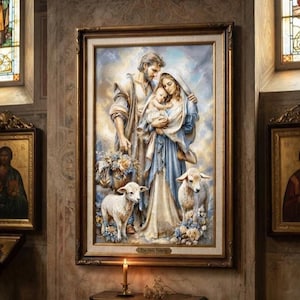 Könnte beinhalten: Ein gerahmter Kunstdruck mit dem Titel The Holy Family, der einen Mann, eine Frau und ein Kleinkind in einem blau-cremefarbenen Gewand zeigt, umgeben von zwei weißen Lämmern und floralen Akzenten vor einem weichen, bewölkten Hintergrund.