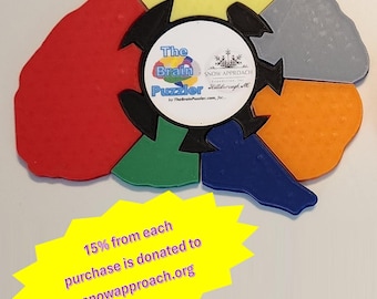 May include: A colorful brain-shaped puzzle with a black center piece that reads "The Brain Puzzler" and "SNOW APPROACH Foundation for Hillsborough, NC". 15% of each purchase is donated to snowapproach.org.