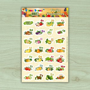 May include: A sticker sheet featuring colorful illustrations of fruits and vegetables, each paired with a letter of the alphabet. The sheet includes images of apples, bananas, carrots, and more, with the words "Fruits Vegetables" at the top.