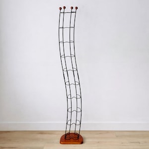 May include: A white ceramic mug with a black handle and the text "But first, coffee" in a handwritten style. The mug is on a white surface.