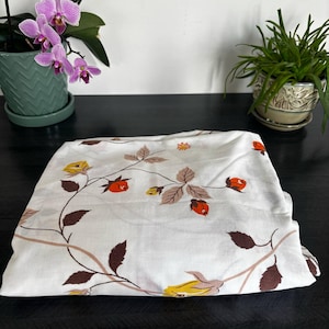 Vintage flat sheet for double bed with red, yellow and brown floral pattern on white background, retro 70s style soft bed linen