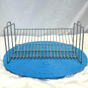 Vintage grey metal CD rack with a 20-disc capacity, retro 2000s music storage stand, minimalist office decor