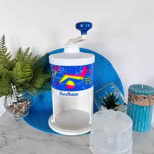 Vintage SnoMotion Ice Shaver – Retro 80s Snow Cone Machine with Neon Graphics – Manual Ice Crusher with Molds – Summer Kitchen Fun