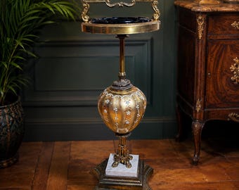 Large vintage standing ashtray with black glass and decorative base in Hollywood Regency style, 30 inches