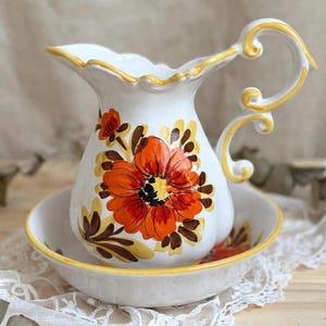 Vintage hand-painted ceramic pitcher and basin with orange and yellow floral decoration, made in Italy