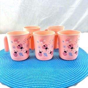 Set of 5 vintage pink Tupperware cups with ladybug and flower design, retro 80s style, children's kitchen