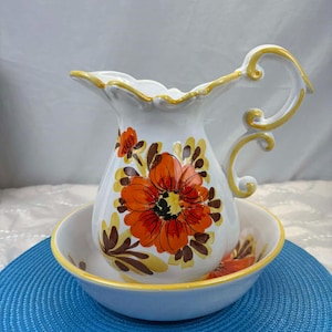 Vintage hand-painted ceramic pitcher and basin with orange and yellow floral decoration, made in Italy