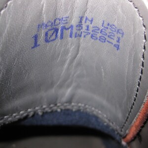 May include: Close-up of the inside of a shoe with a blue label that reads "Made in USA 10M W768-4".