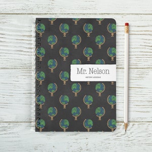 May include: A black spiral notebook with a repeating pattern of globes on the cover. The notebook has a label that says "Mr. Nelson History Lessons".