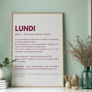 May include: A printable wall art poster with a definition of the French word "Lundi" (Monday) in a minimalist style. The poster features a white background with black text and a burgundy title.
