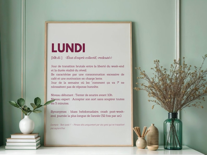 May include: A printable wall art poster with a definition of the French word "Lundi" (Monday) in a minimalist style. The poster features a white background with black text and a burgundy title.