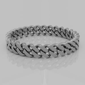 May include: A silver chain ring with a curb link design.