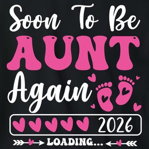 May include: Black t-shirt with the text "Soon To Be AUNT Again" in white and pink. The design includes baby footprints, hearts, and the year 2026. The shirt is displayed on a wooden tray with festive decorations.