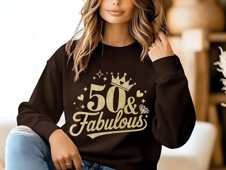 May include: A black sweatshirt with gold glitter lettering that says "50 & Fabulous" with a crown above the 50.