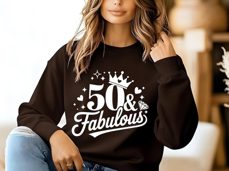May include: A black sweatshirt with a white graphic design that says "50 & Fabulous" with a crown and a diamond.