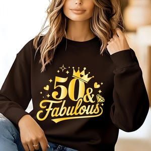 May include: A black sweatshirt with a gold graphic that says "50 & Fabulous" with a crown and a diamond.