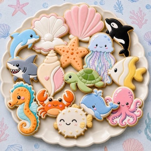 May include: A collection of ocean-themed sugar cookies on a white scalloped plate, featuring a dolphin, shark, seahorse, crab, pufferfish, whale, octopus, sea turtle, jellyfish, starfish, orca, and various seashells decorated with colorful icing.