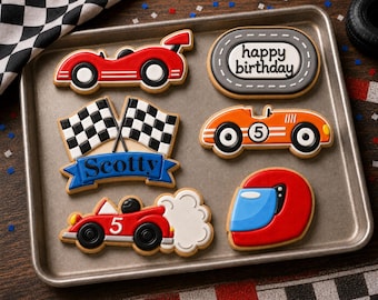 Peut inclure: Un ensemble de six biscuits décorés sur un plateau en métal, comprenant deux voitures de course rouges et orange, un biscuit ovale gris avec le texte happy birthday, deux drapeaux à damier au-dessus d'une bannière bleue avec le nom Scotty.