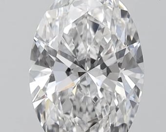 May include: A clear, oval-cut diamond with many facets. The gemstone is colourless, reflecting light. The diamond is set against a neutral background, highlighting its sparkle and clarity. Suitable for engagement rings or fine jewellery.