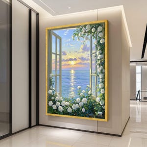 Puede incluir: Pintura enmarcada que representa una ventana abierta con vistas a una puesta de sol sobre el mar. Rosas blancas y vegetación enmarcan la ventana. La pintura tiene un marco dorado y está montada en una pared beige.