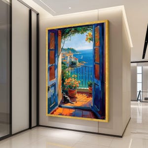 May include: A framed painting depicts a vibrant coastal scene. The artwork showcases an open blue door framing a balcony with potted flowers, a black cat, and a view of the sea and buildings. The painting has a gold frame.