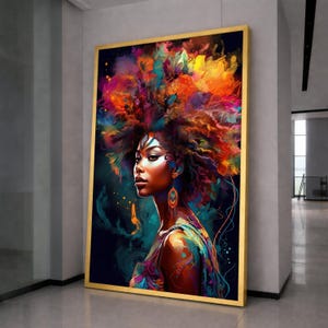 May include: A framed art print depicting a woman with a striking, colourful hairstyle and clothing. The artwork uses blues, oranges, and yellows, set within a gold frame. The woman has brown skin and is wearing earrings. The overall style is artistic and bold.