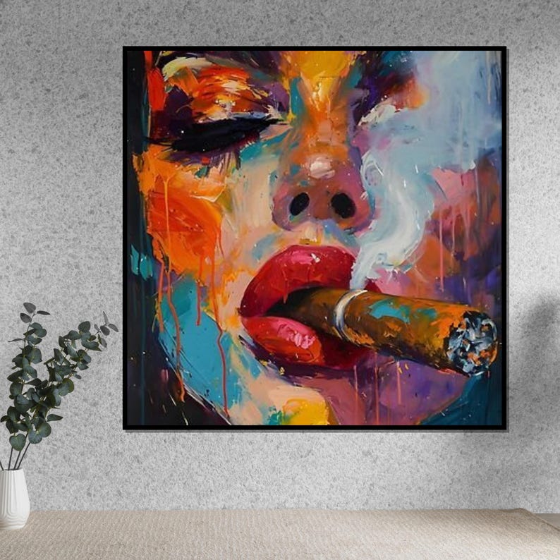 May include: Abstract oil painting of a face with closed eyes, vibrant colors, and a cigar. The artwork features bold brushstrokes, with red lips, and smoke. The painting is framed in a black square.