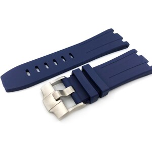 May include: A dark blue silicone watch strap with a silver buckle. The strap has a textured surface and is designed for a watch with a lug width of 22mm.