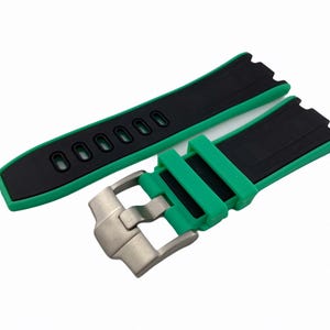 May include: A black and green watch strap with a stainless steel buckle. The strap has a textured surface and is designed for a watch with a lug width of 22mm.