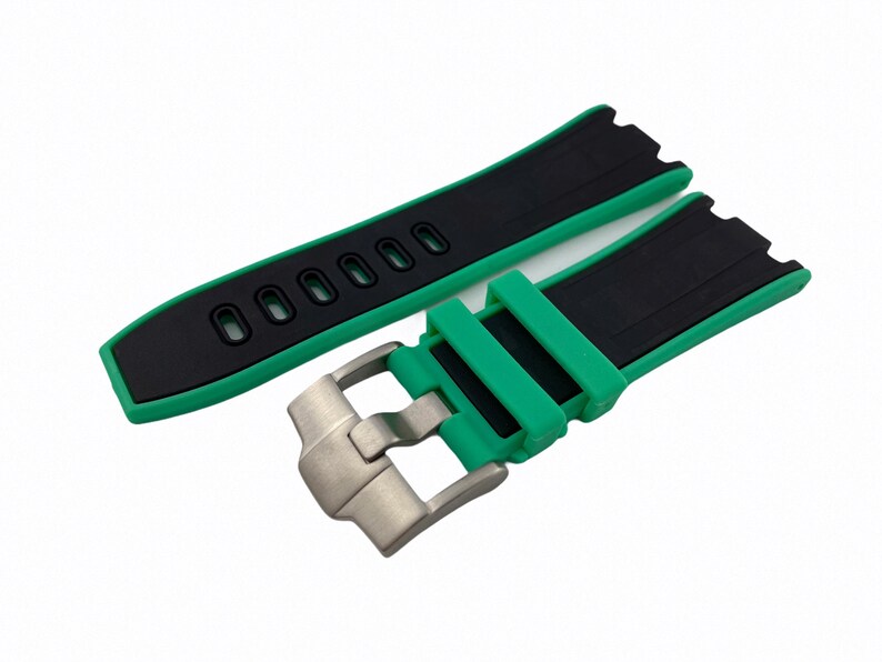 May include: A black and green watch strap with a stainless steel buckle. The strap has a textured surface and is designed for a watch with a lug width of 22mm.