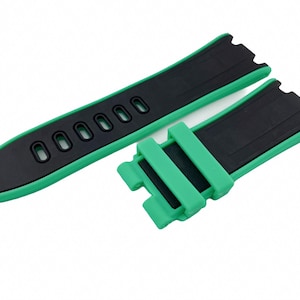 May include: A green and black watch strap with a buckle. The strap has a textured surface and is made of silicone.
