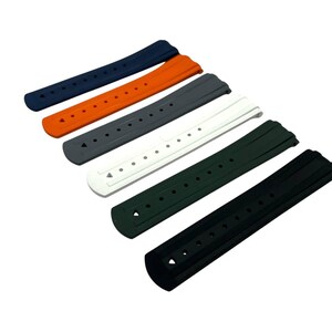 May include: A collection of six watch straps in various colors: navy blue, orange, gray, white, dark green, and black. Each strap has multiple holes for adjustment and a curved design for a comfortable fit.