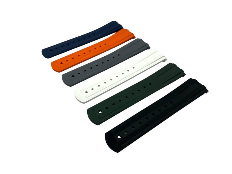 May include: A collection of six watch straps in various colors: navy blue, orange, gray, white, dark green, and black. Each strap has multiple holes for adjustment and a curved design for a comfortable fit.