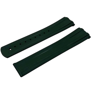 May include: Dark green watch strap, featuring a ribbed design. The strap is made of a flexible material and has several holes for adjustment. The watch band is shown against a white background.