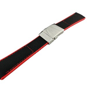 May include: A black and red watch strap with a silver buckle. The strap is made of a textured fabric with red stitching.