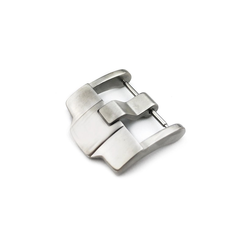 May include: A silver metal watch band buckle with a smooth, polished finish.