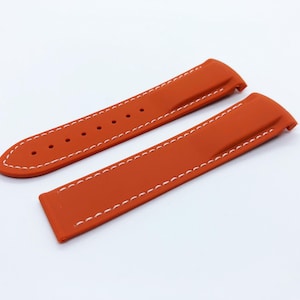 May include: Two orange silicone watch straps with white stitching. The straps are designed for a watch with a lug width of 22mm.