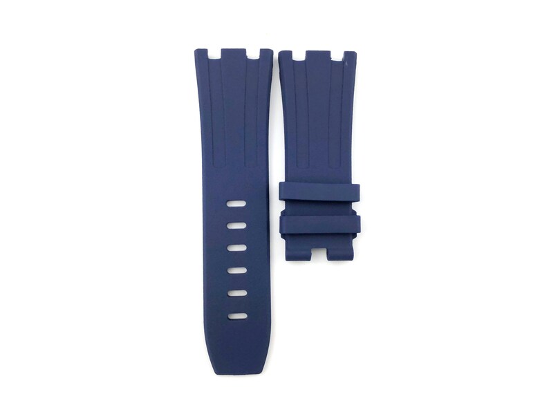 May include: A dark blue silicone watch strap with a buckle closure. The strap has a textured design and is compatible with watches that have a 22mm lug width.