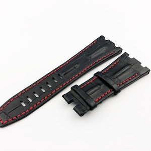 May include: Black leather watch strap with red stitching. The strap has a crocodile pattern and is designed for a watch with a lug width of 22mm.