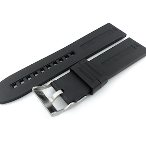 May include: Black rubber watch strap with a stainless steel buckle. The strap has a textured surface and is designed for a watch with 22mm lugs.