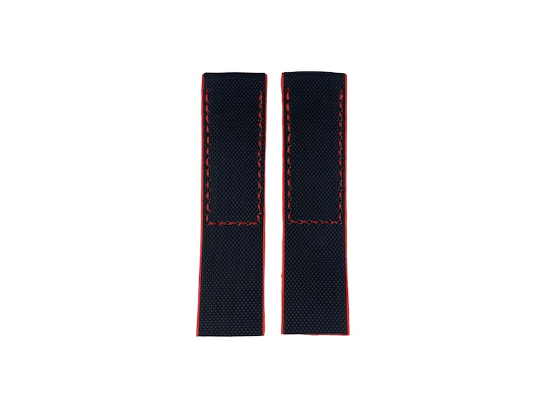 May include: Two black watch straps with red stitching. The straps are made of a textured fabric.