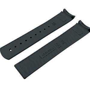 May include: Two-piece dark gray watch strap. The strap has a curved design to fit the watch case. One piece has holes for adjustment, the other has the text "20" and "HJC" and the code "CV2010127".