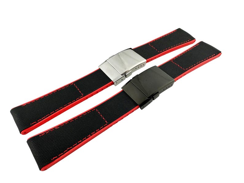 May include: Two black watch straps with red stitching and different metal buckles. One buckle is silver and the other is black.