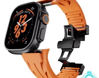 May include: Orange silicone watch band with a black buckle and a black case for an Apple Watch. The watch face displays the time, date, and weather.