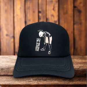 May include: Black trucker hat with a curved brim and mesh back. The front features a white graphic of a person with a halo, bent over, with the text "I WOULD SET MYSELF ON FIRE FOR YOU."