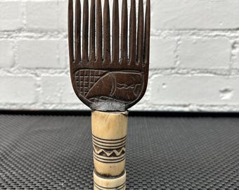 Ivory Coast hair comb with Ivory handle .