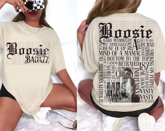 May include: A beige t-shirt with a black graphic print of the text "Boosie Badazz" and a list of lyrics from the song "Set It Off" by Boosie Badazz.
