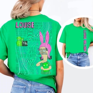 May include: A bright green t-shirt featuring a large graphic on the back with the text LOUISE, SICK, and MAS. The design includes a cartoon character with pink bunny ears and a green creature. The front of the shirt displays the text LOUISE BELCHER.
