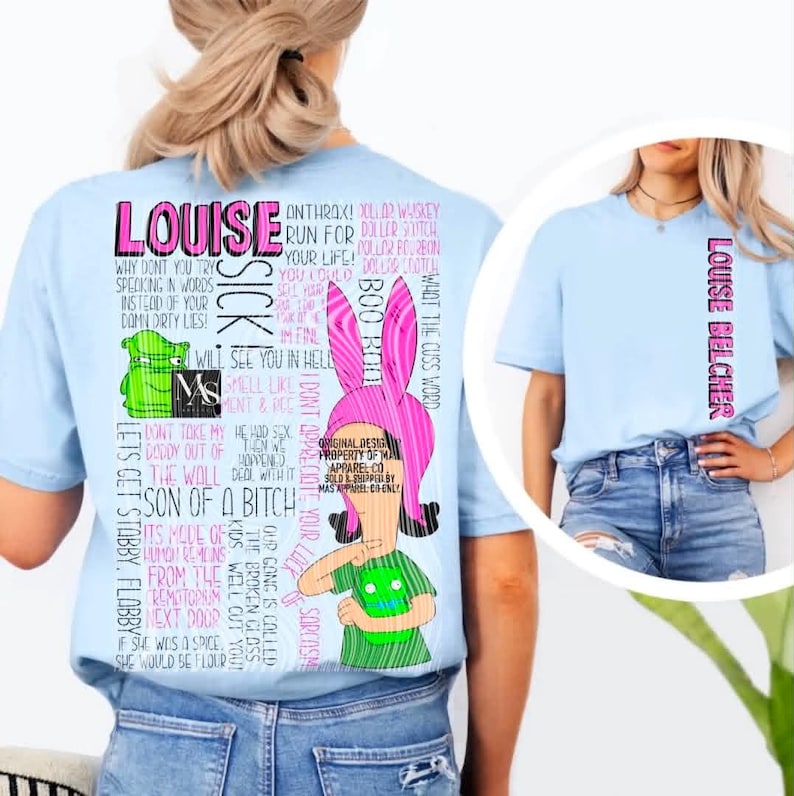 May include: A light blue t-shirt featuring a graphic of a cartoon character with pink bunny ears and a green shirt. The back displays extensive text including "LOUISE," "SICK," and various phrases. The front features the text "LOUISE BELCHER."
