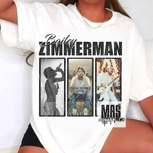 May include: White t-shirt featuring the name "Bailey Zimmerman" above three framed images. The images depict Zimmerman in various poses, including singing and playing guitar. The text "MAS Apparel Co" is also visible.